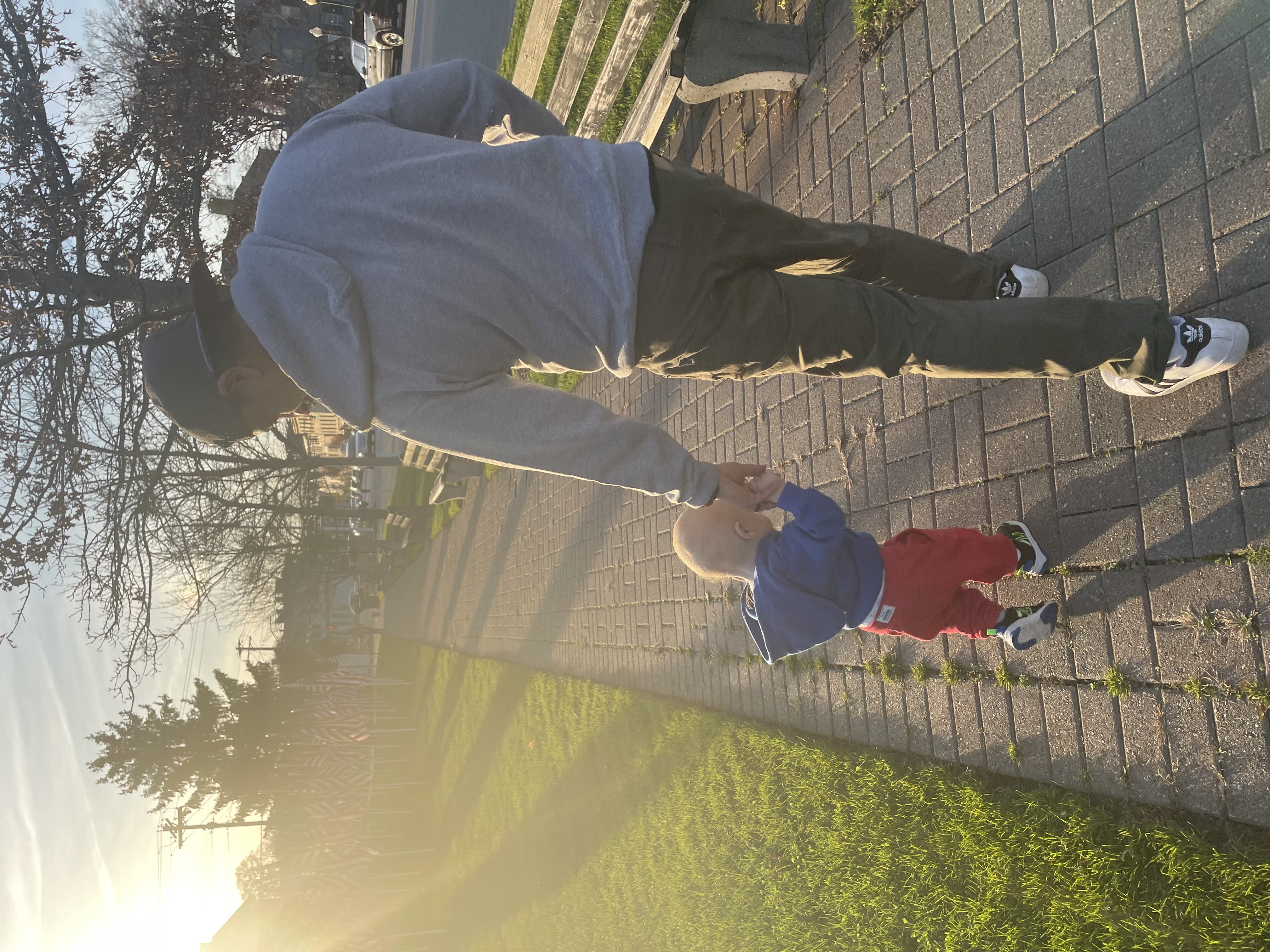 A picture of my son and I walking into the sunset.